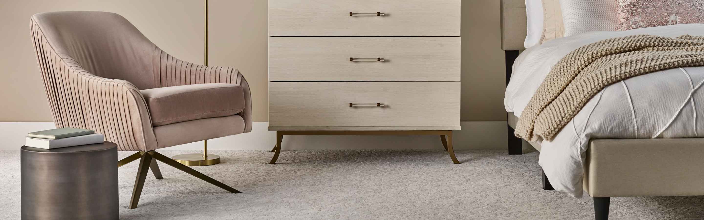 light carpet in bedroom with cream fabric bed and light wood midcentury modern end table
